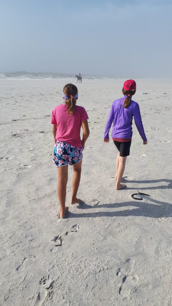 children walking the beach shaping their destiny