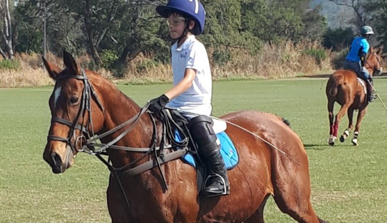 Murray John playing polo on Silver.