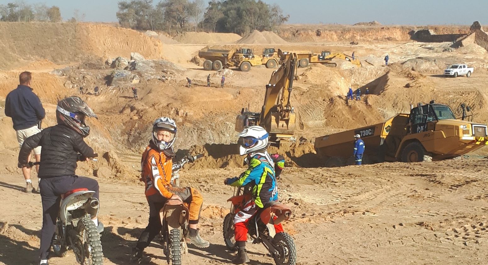 Riding motorbikes to see the dam wall being built