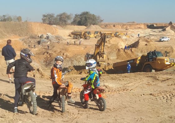 Riding motorbikes to see the dam wall being built