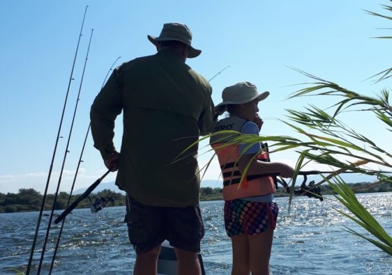 Father fishing with daughter