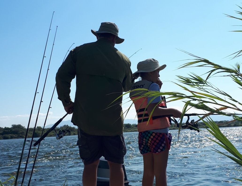 Father fishing with daughter