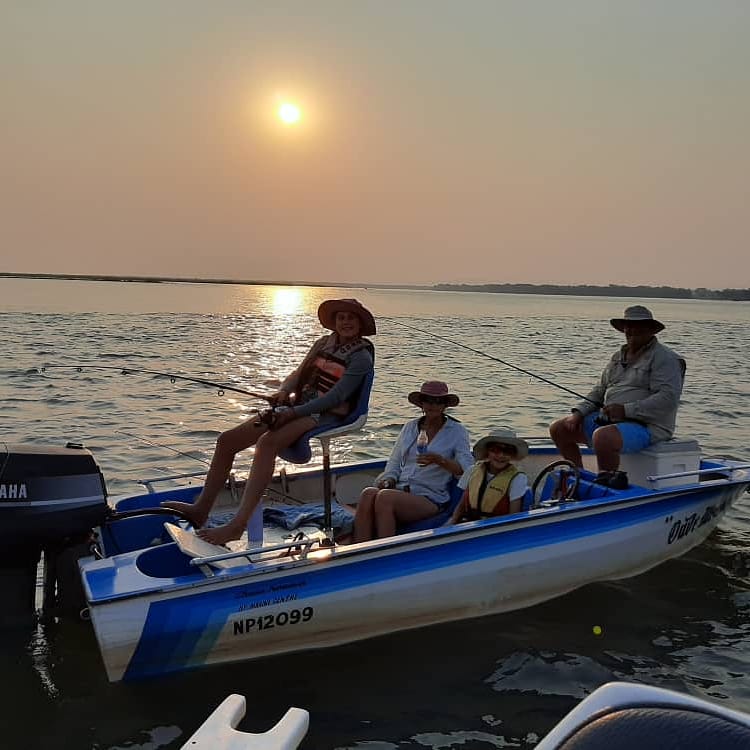 family bonding time fishing on the zambezi river. 