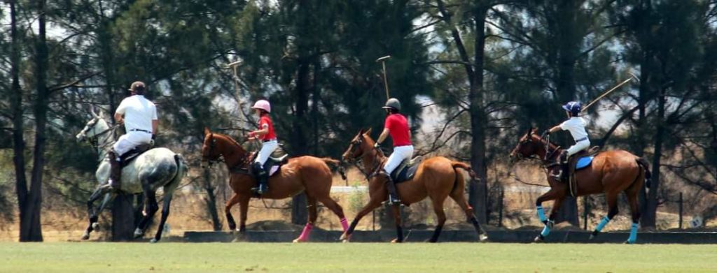 family playing polo together. 