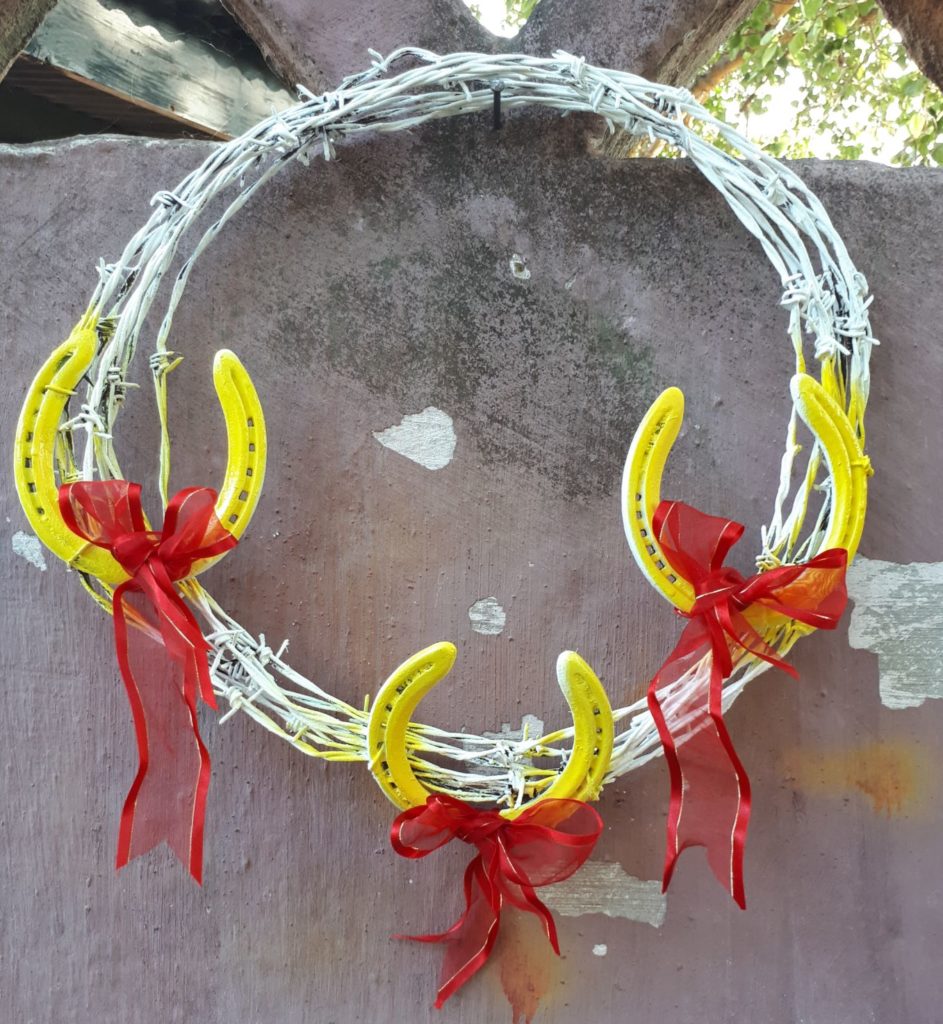 horse shoe wreath with barbed wire.