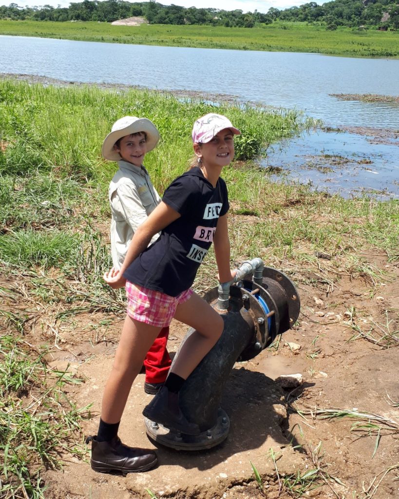 kids at the pump inlet pipe at the dam. 