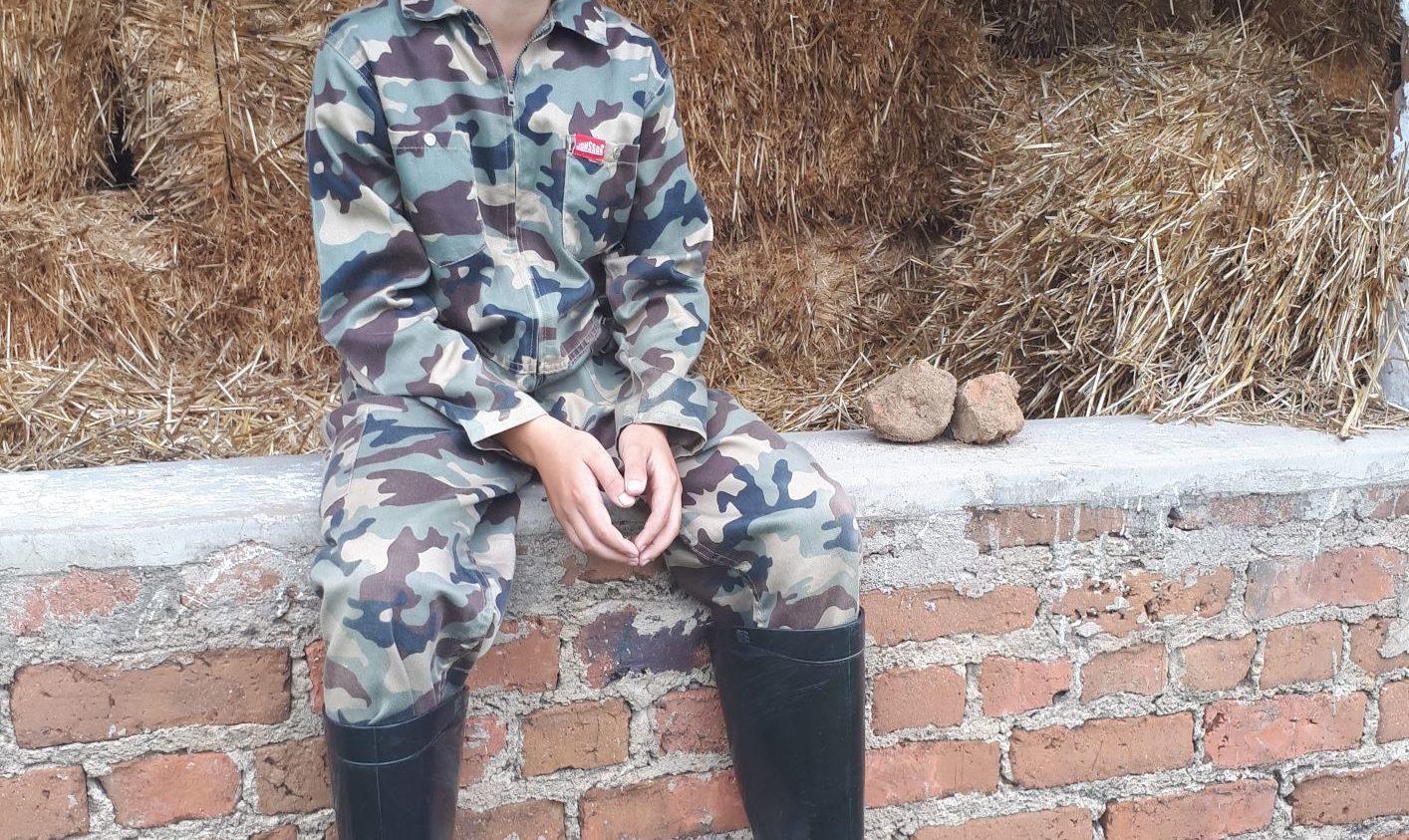 boy sitting on a wall thinking.