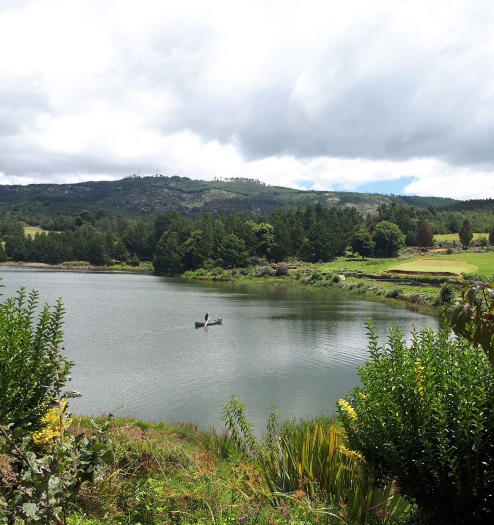 Happy boy canoeing across the dam on his adventure in Nyanga Zimbabwe. 