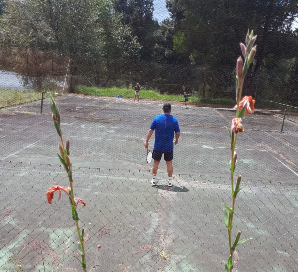 tennis match kids verses dad. 