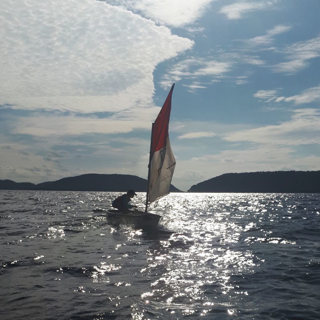 Murray John sailing his Opie in the late afternoon. 