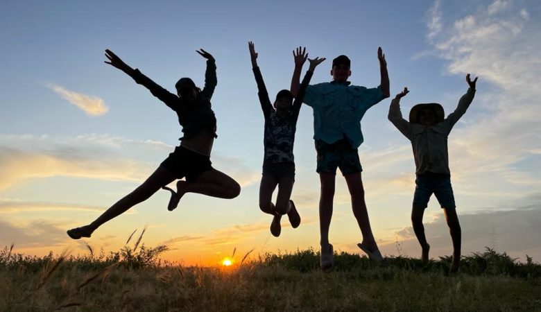 kids jumping in the sunset