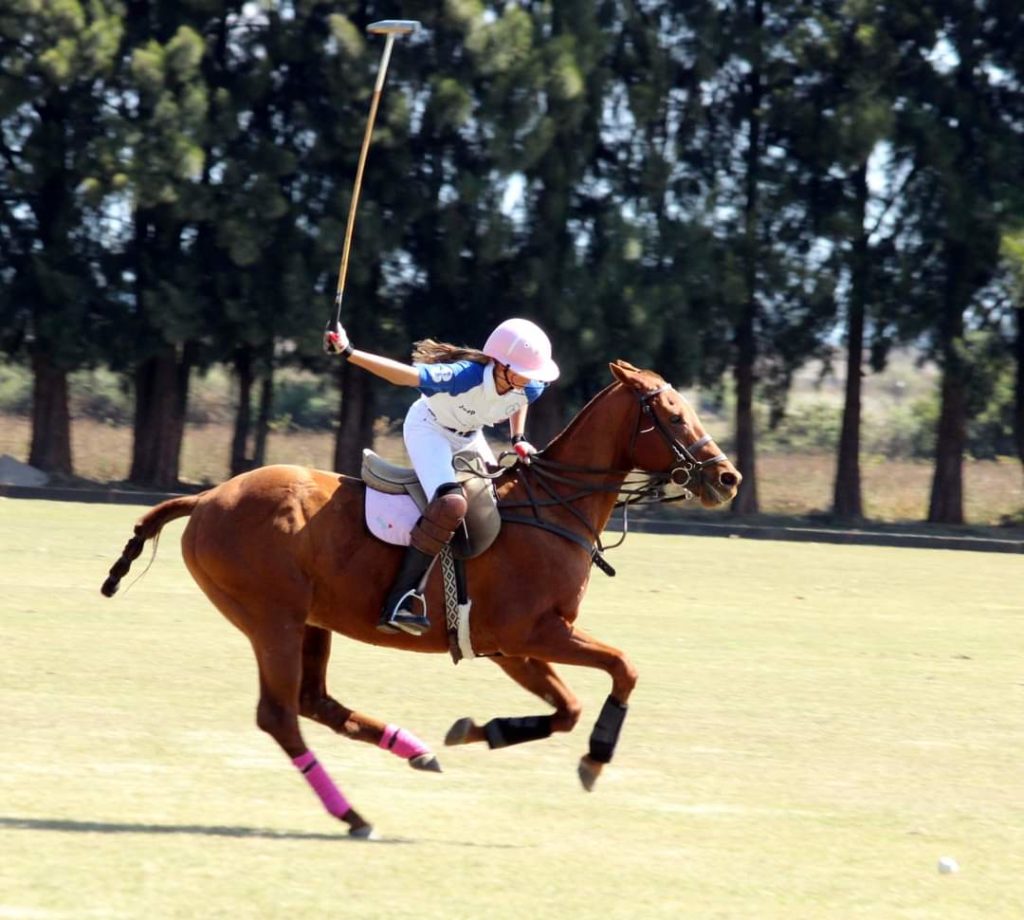 Paula Joy hitting the polo ball. 