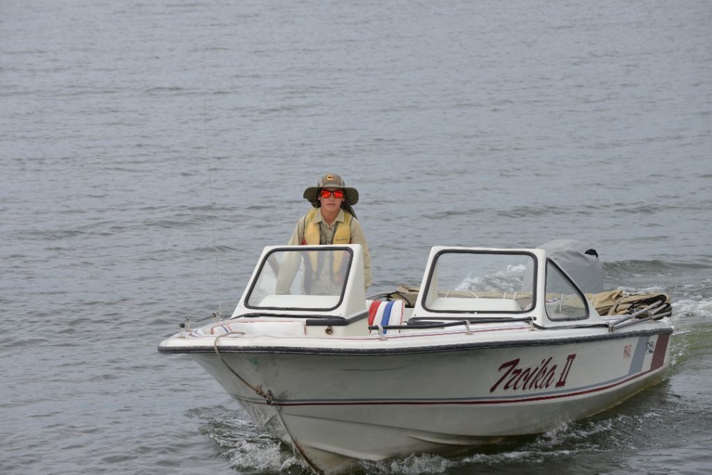 Houseboat life Skills.  Murray John driving the speed boat. 