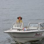 boy driving speed boat